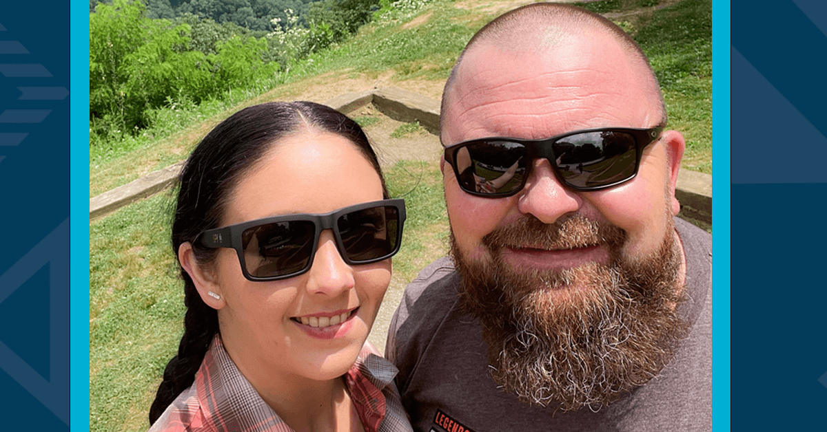 A selfie of Capital One associate Amanda and her husband outside wearing sunglasses